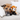 A brown dog rests on a light beige sofa next to a small red panda plush toy, with white pillows in the background.