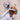 Dog playing with a plush toy on a beige surface