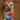 Dog holding a colorful ball in its mouth on a brown background