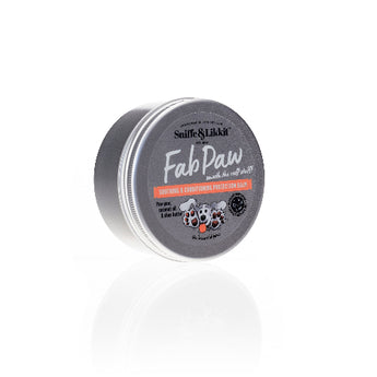 A tin container of Sniffe & Likkit Paw Balm, designed for pet use, with text highlighting its benefits for dry skin and minor irritations.