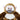 A plush monkey toy with brown fur, a white chest and face, pink inner ears, and a gray snout, photographed against a plain white background.